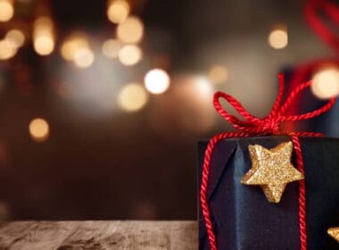Wertvolles Weihnachtsgeschenk mit funkelnden Lichtern im Hintergrund